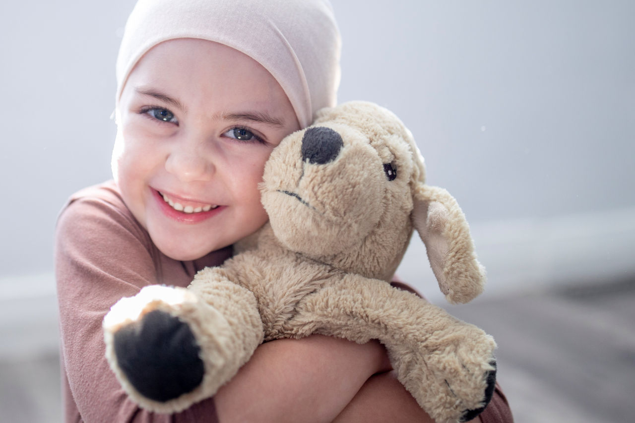 Girl hugging stuffed animal Girl hugging stuffed animal