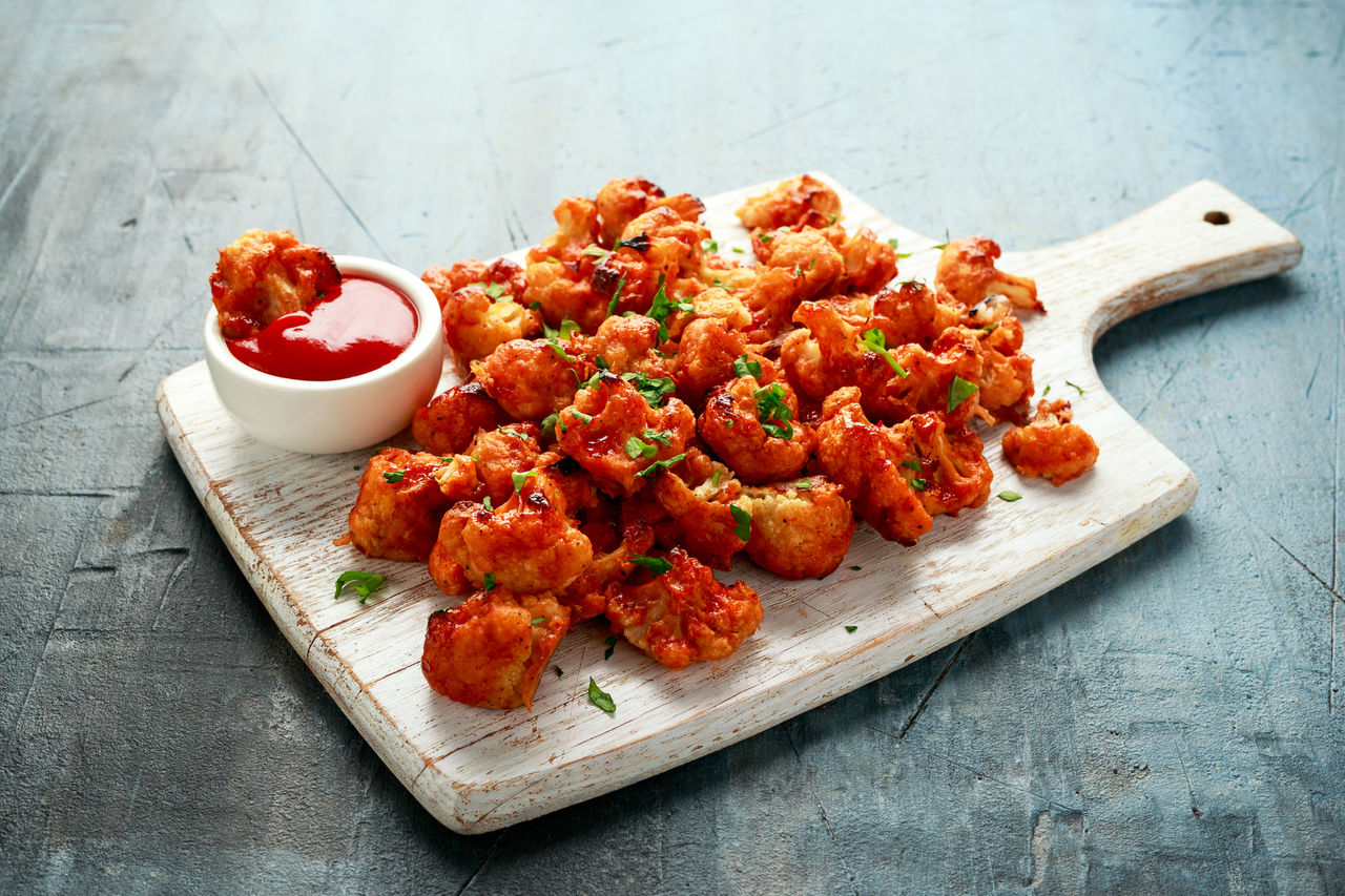 Buffalo cauliflower meal on a serving board Buffalo cauliflower meal on a serving board