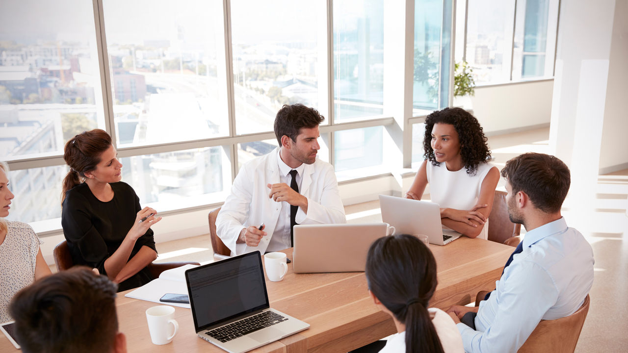 A group of professionals meeting in a conference room.