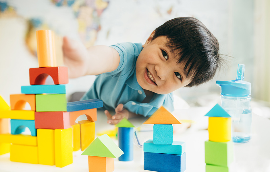 Small child playing with blocks on the floor