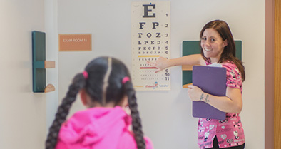 A Newark staff member performs a vision test.