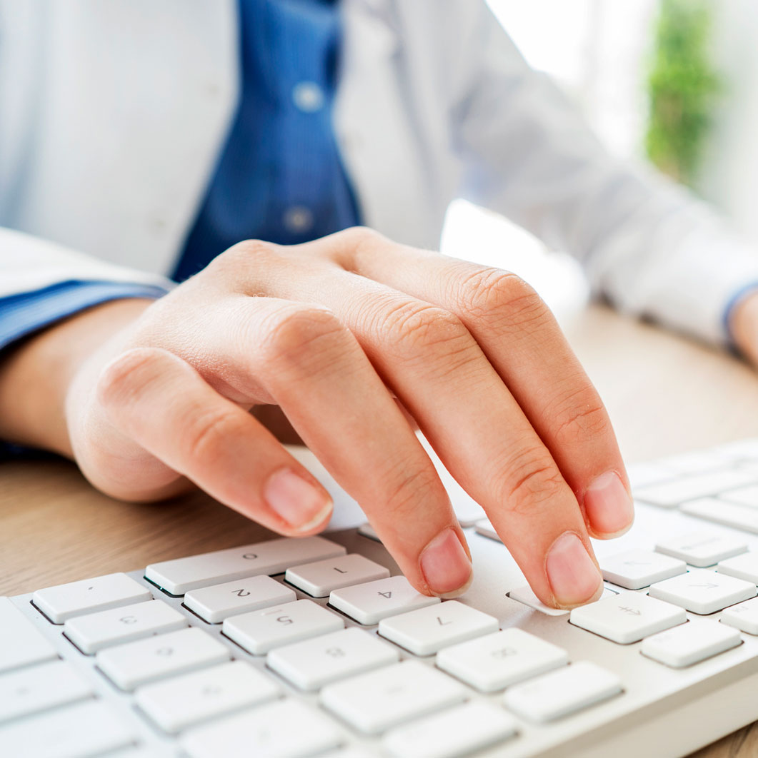 Close up of fingers using a computer keyboard. 