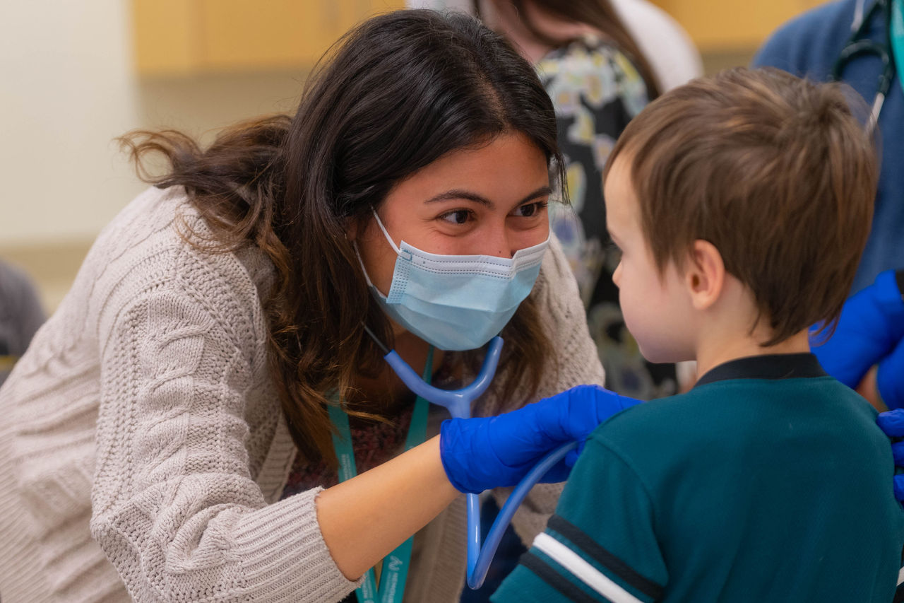 Pediatric nurse with child.