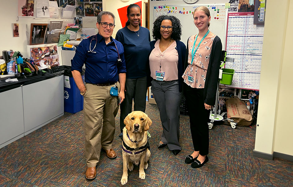 Four people standing with a dog in front for Health Equity, Leadership and Advocacy in Primary Care Track.