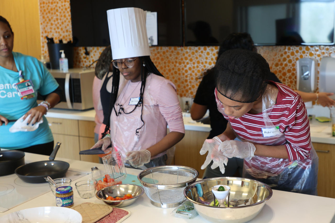 Teens learning in kitchen