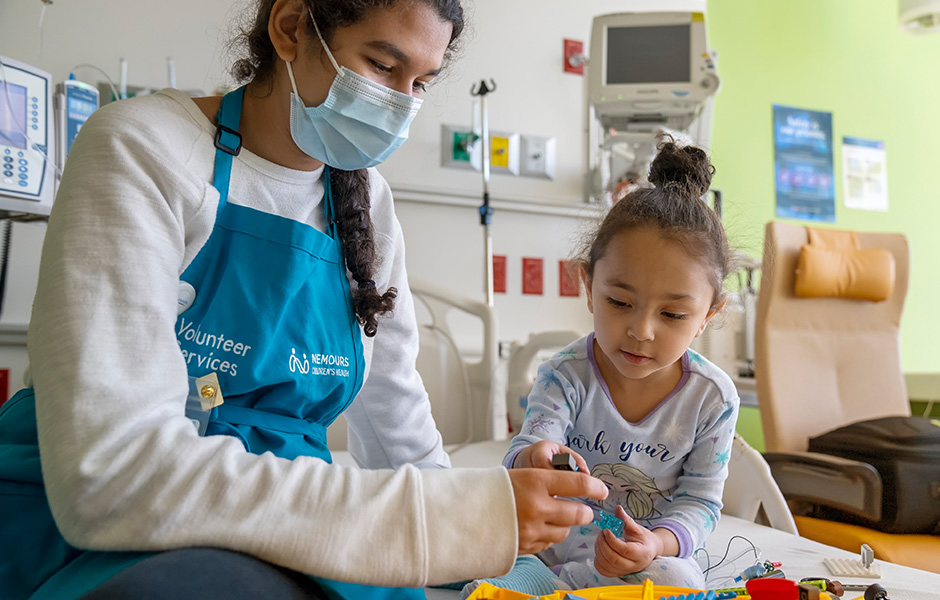 Volunteer working with a patient in bed
