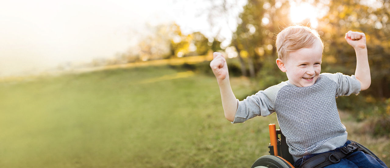boy in wheelchair cheering up