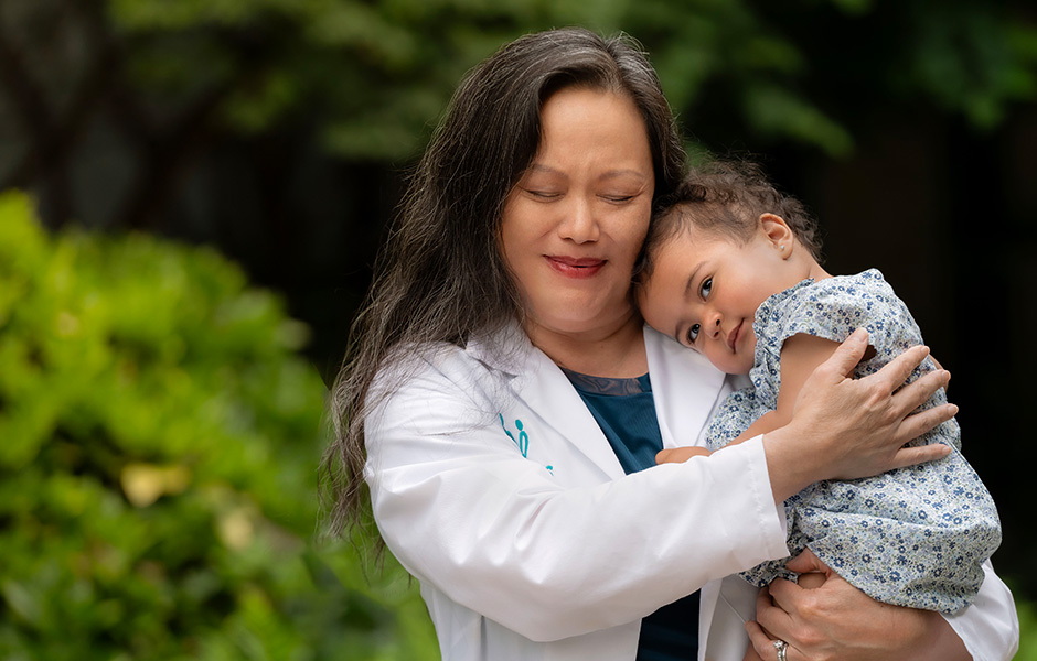 Dr. Chou holding baby Raegan.