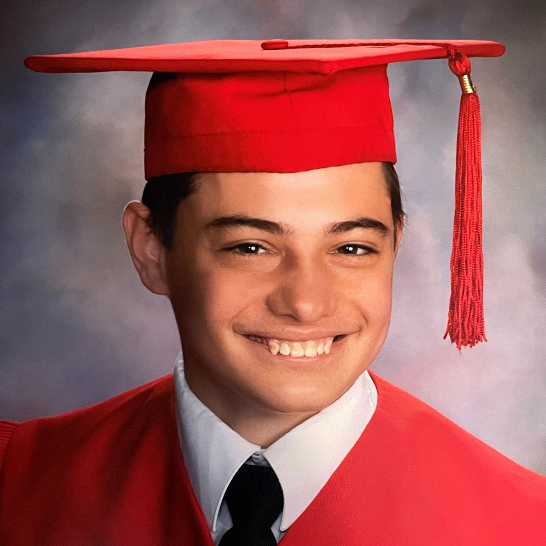 This is a high school cap-and-gown portrait of Wyatt, a patient who had epilepsy surgery to help with seizures and tuberous sclerosis complex, a condition that causes the growth of noncancerous (benign) tumors.