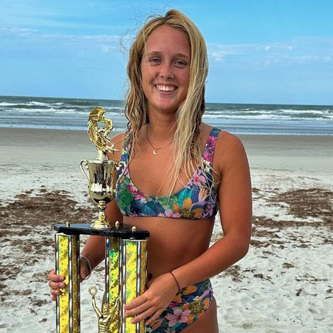 katelyn on the beach with surfing award
