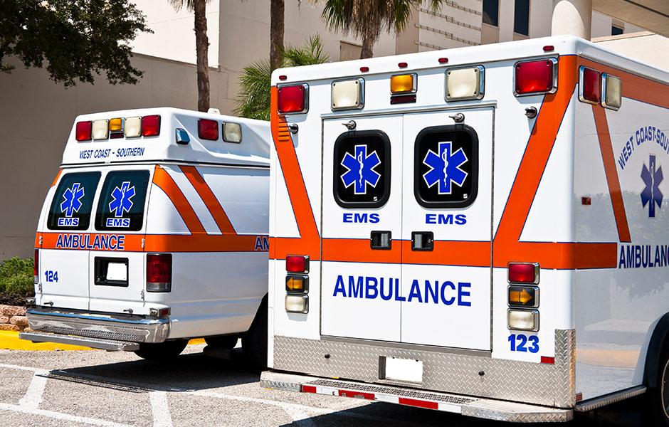 Two parked ambulances Two ambulances parked next to a building