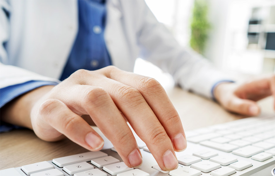 Close up of fingers using a computer keyboard. 