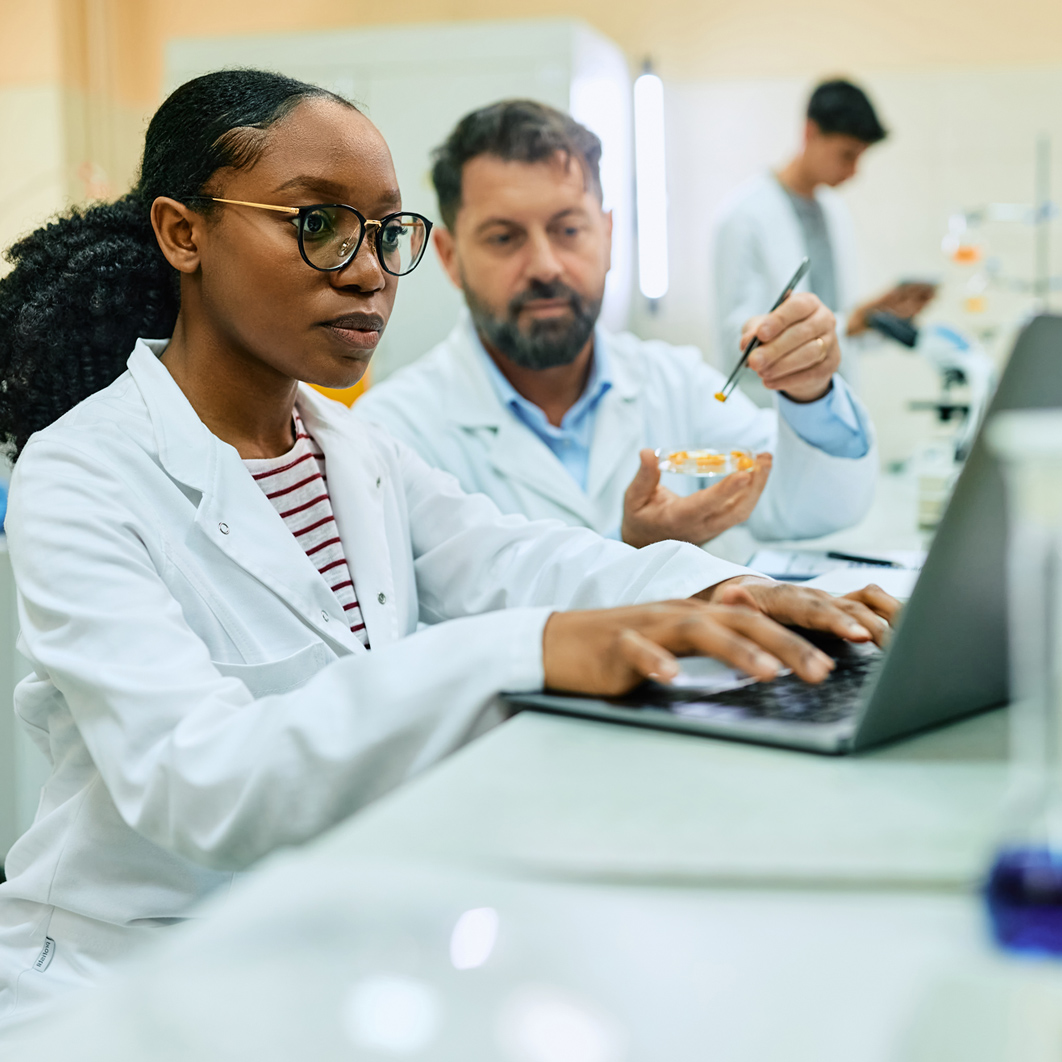Lab techs on computer Lab techs on computer