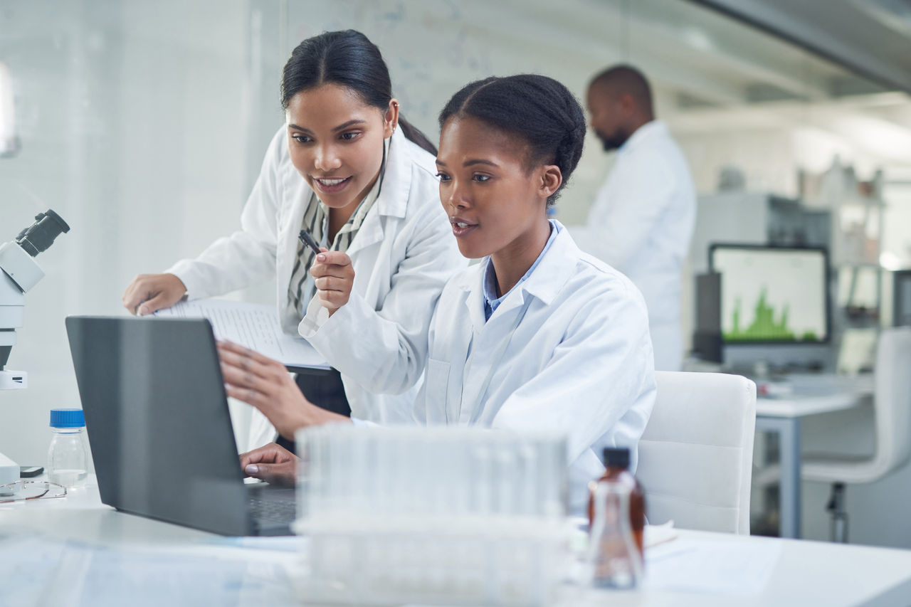Two medical employees reviewing laptop Two medical employees reviewing laptop