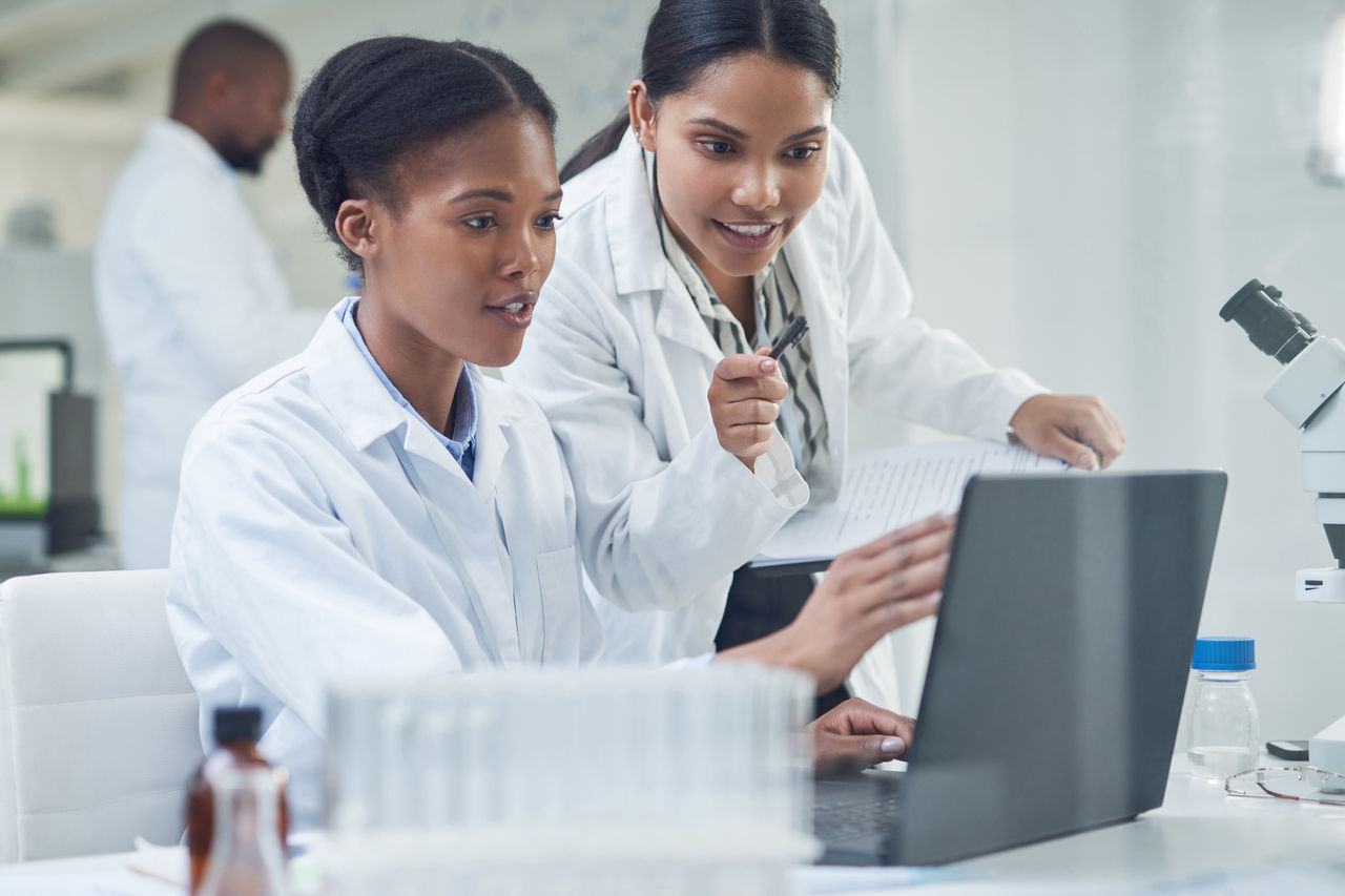 Medical staff looking at laptop monitor