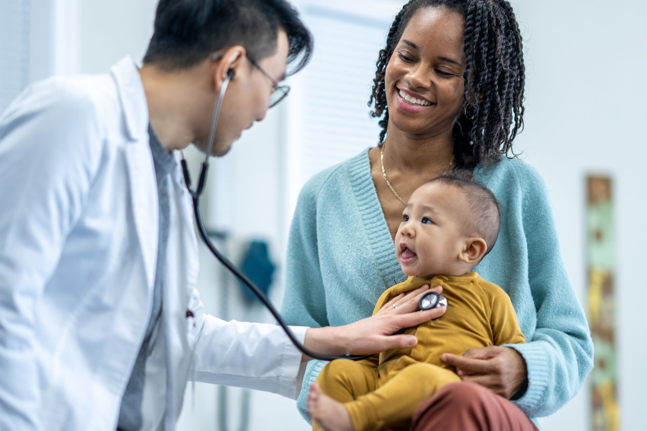 Doctor with baby and mother Doctor with baby and mother