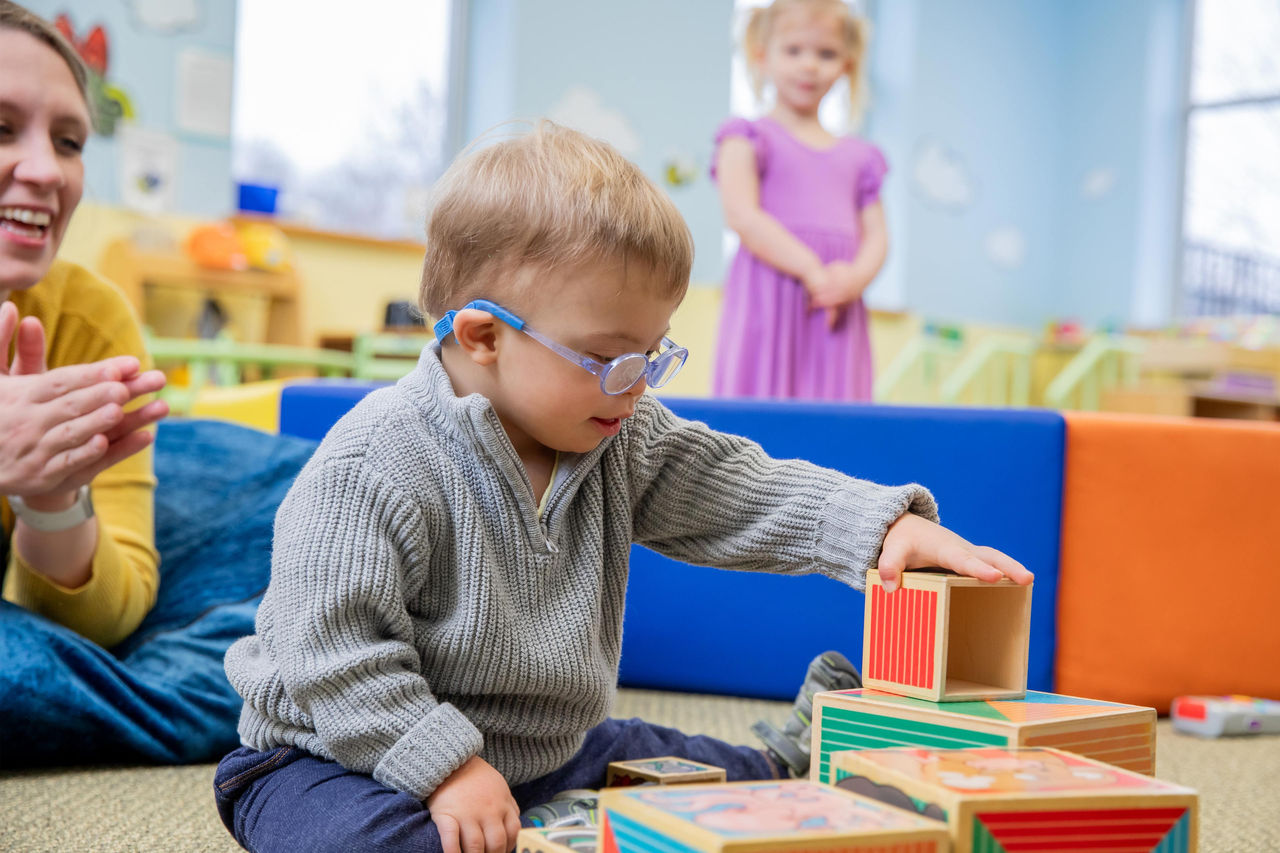 Toddler playing with wooden blocks