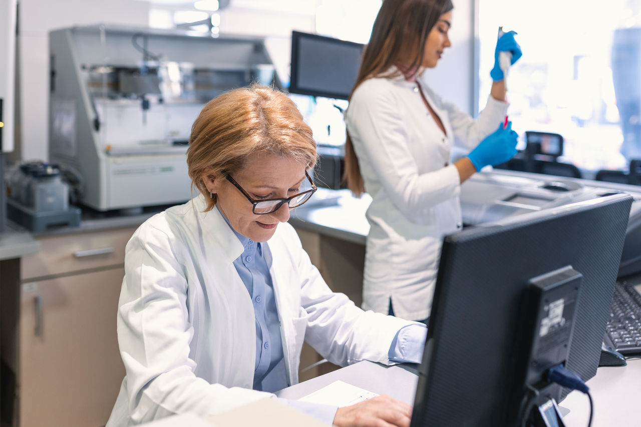Doctor on computer & lab tech Doctor on computer & lab tech