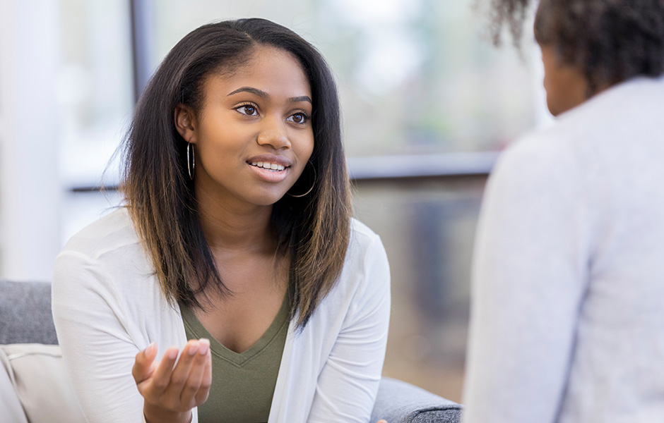 Teenage girl talks to adult female. 