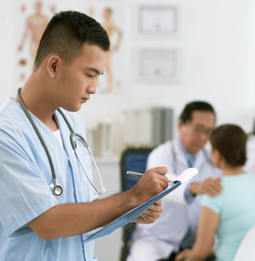 Nurse writing in chart.