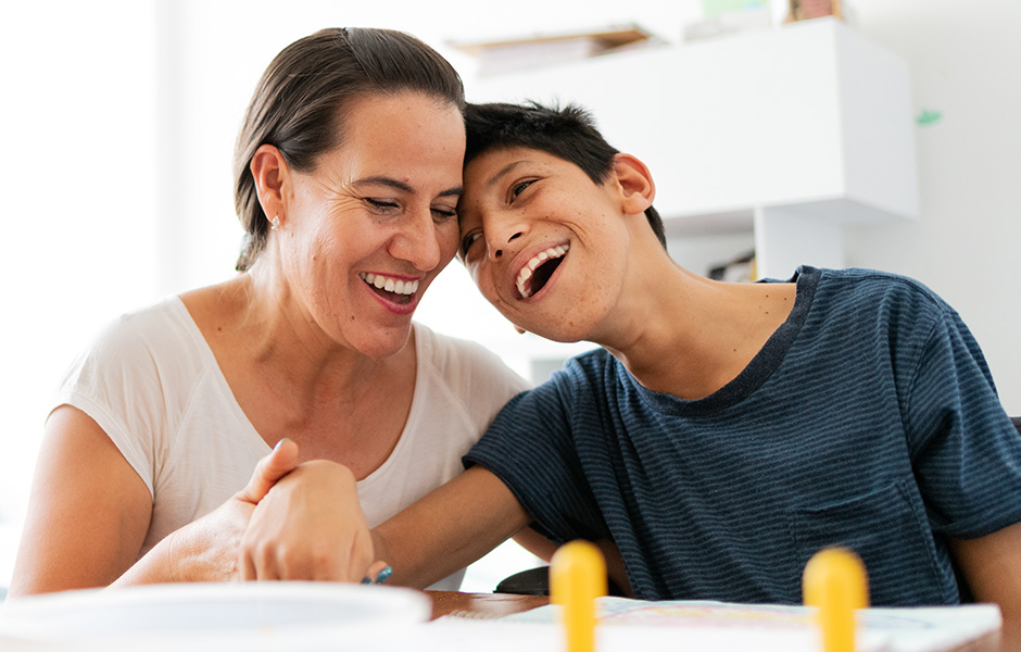 Male patient with special needs works with his female therapist Male patient with special needs works with his female therapist