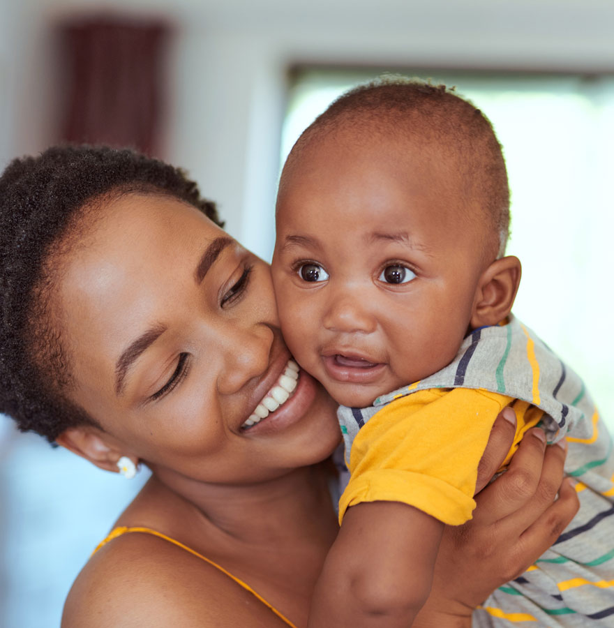 Mother embracing toddler.