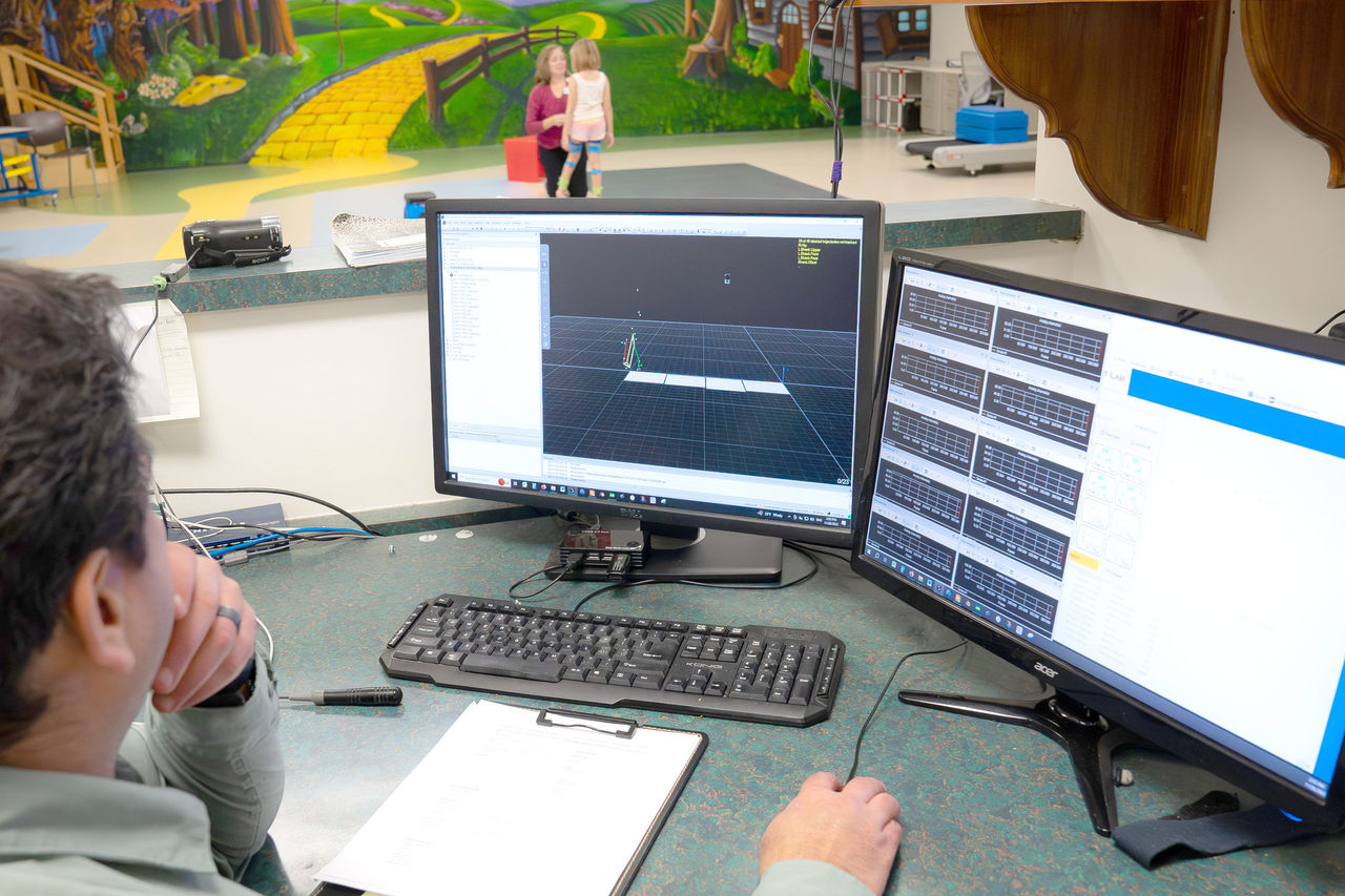 Doctor watching computer screens in gait lab