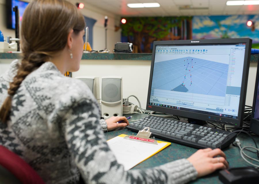 Woman reviewing gait motion analysis on computer screen. 