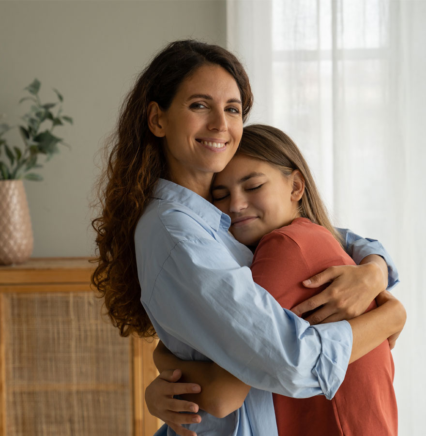 Mom hugging teen age girl