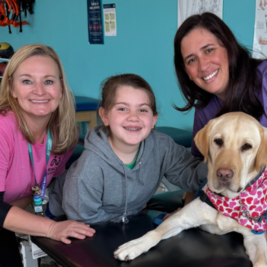 Patient Taylor smiling with 2 caregivers
