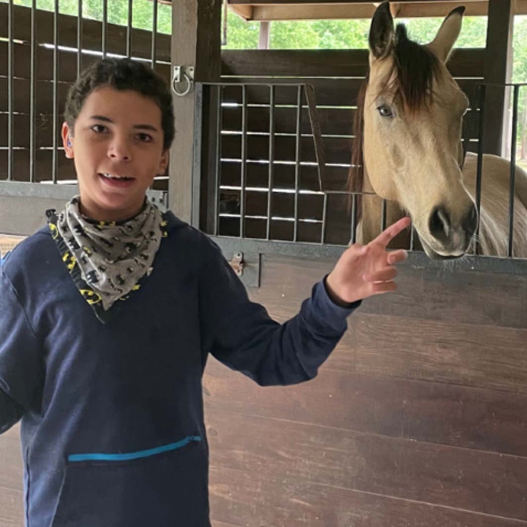 Hudson posing for a photo with a horse