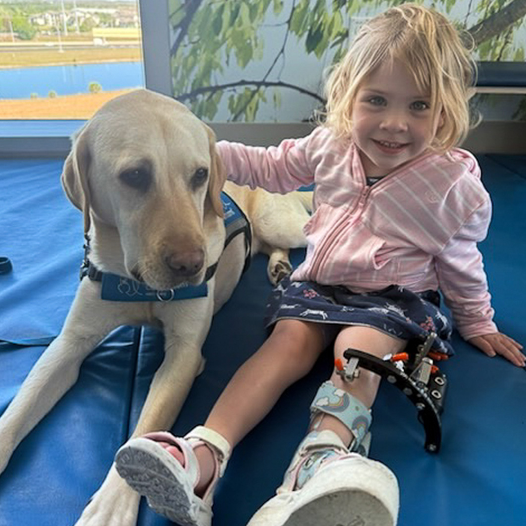 Patient, Charlotte, with therapy dog 