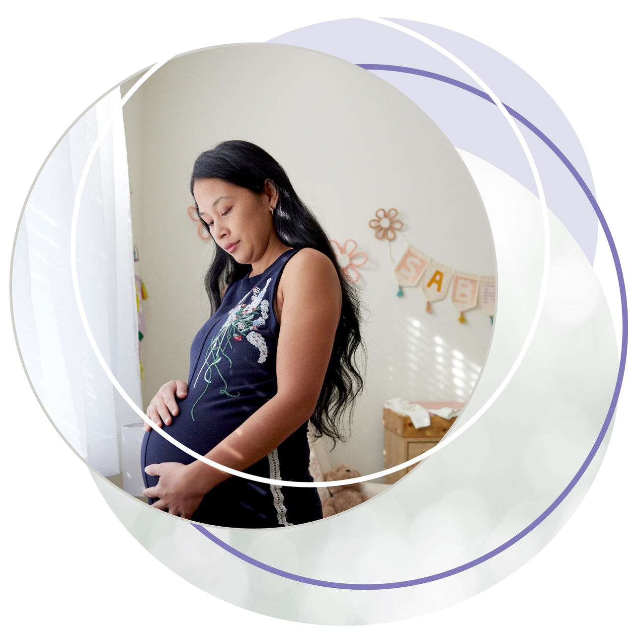 Pregnant woman standing in softly lit nursery