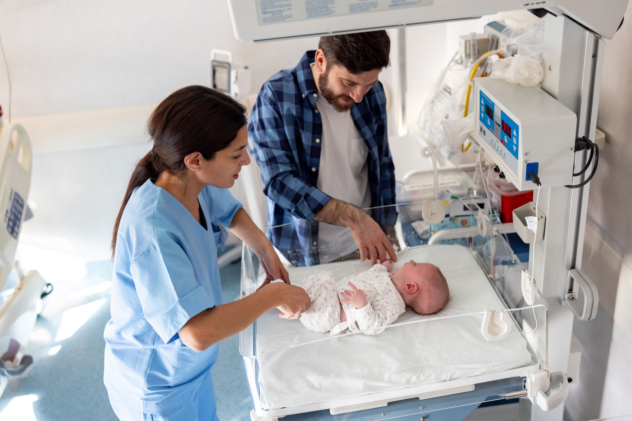 Newborn with nurse and father