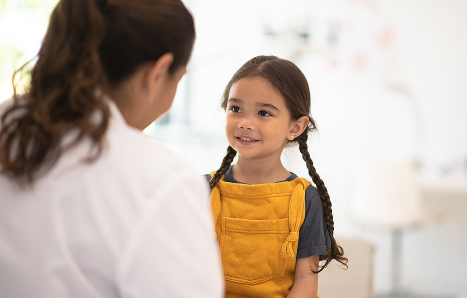 Young female patient listens to female doctor in a lab coat