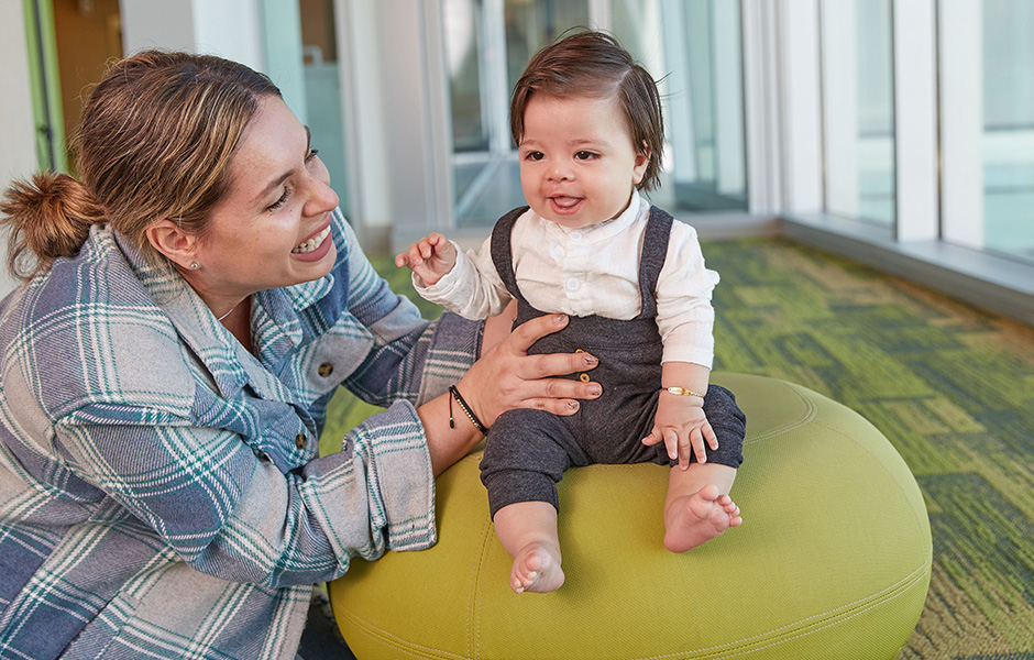 Cleft patient sitting on a stool.
