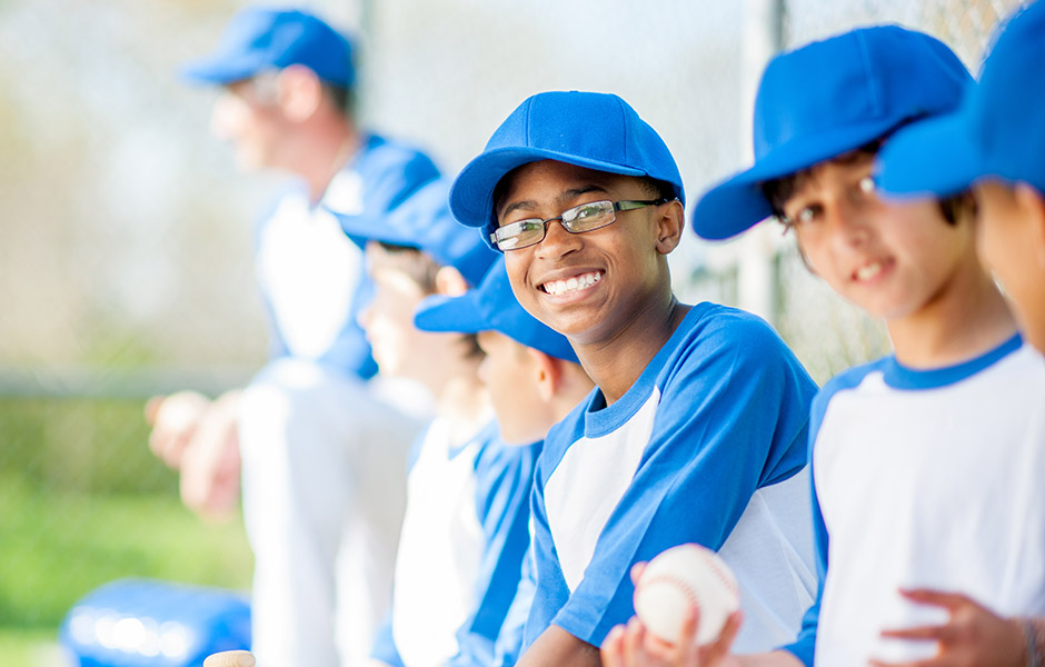 Middle school baseball team sits on the bench 