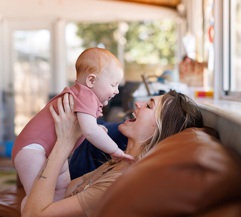 mom and baby playing and laughing