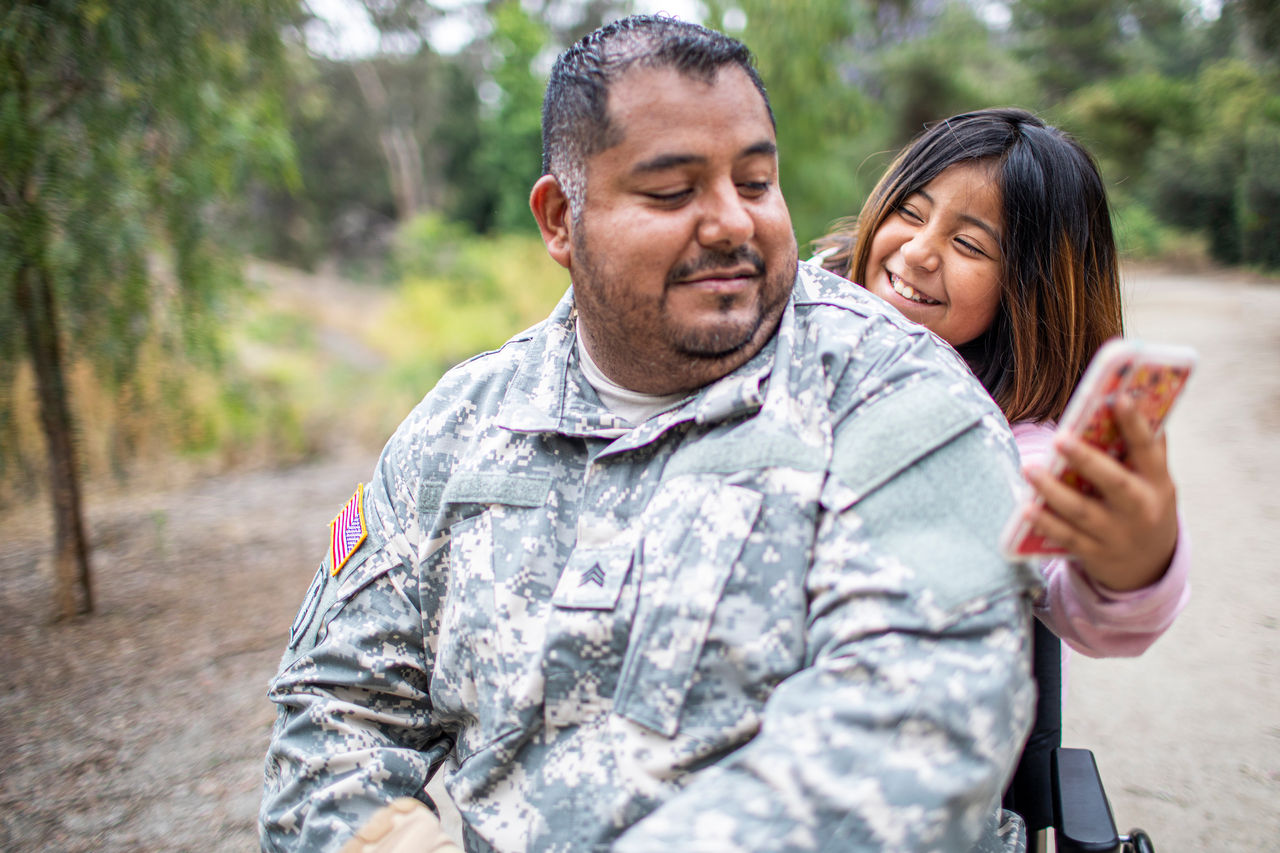 Military father in wheelchair with daughter