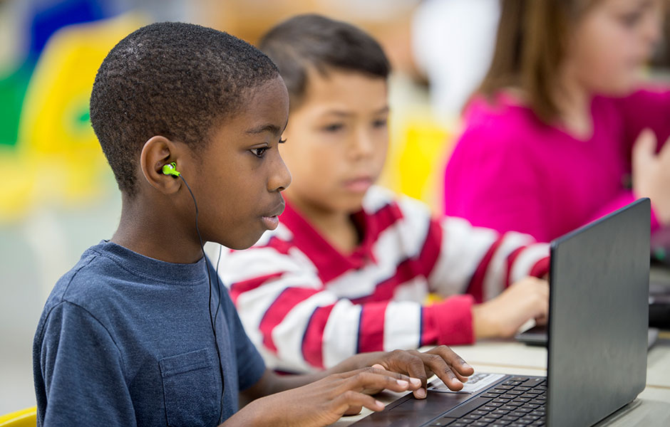 Two students looking at a computer.