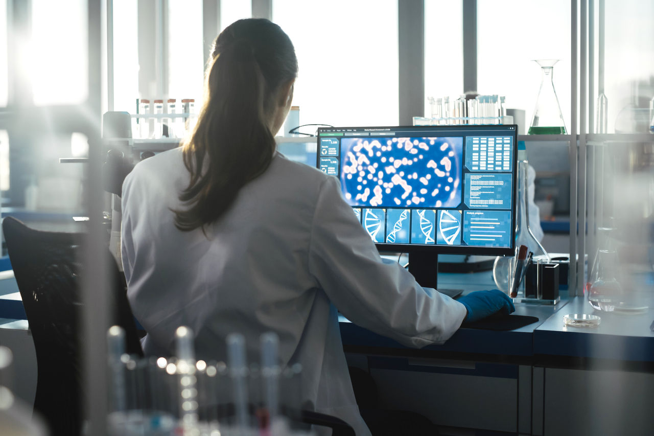 Photo of a doctor sitting at a computer doing research