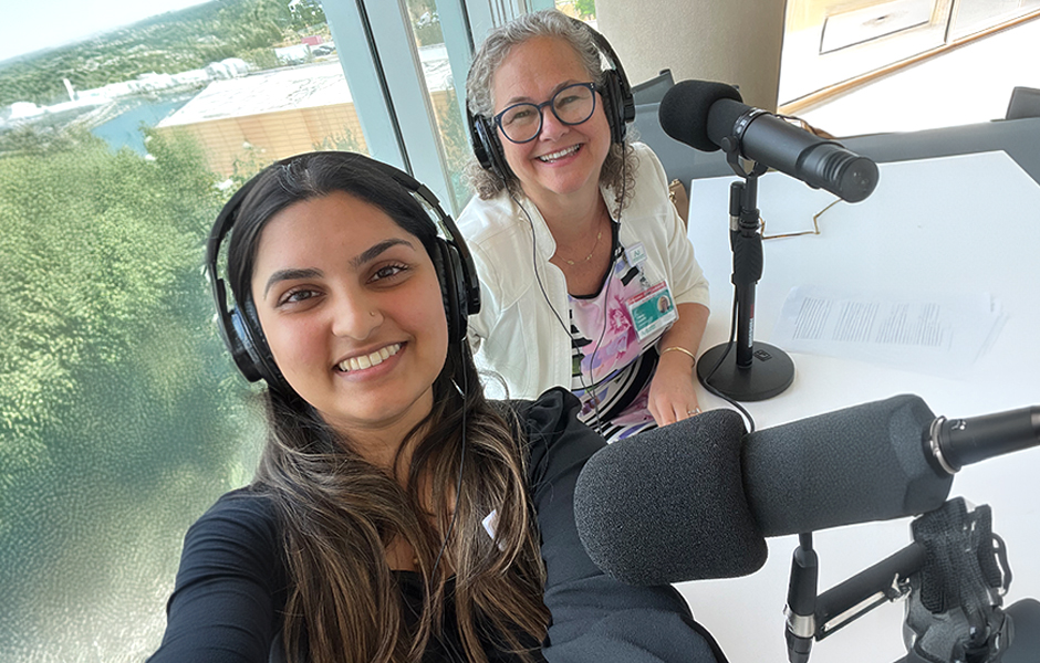Two people in a podcast studio.