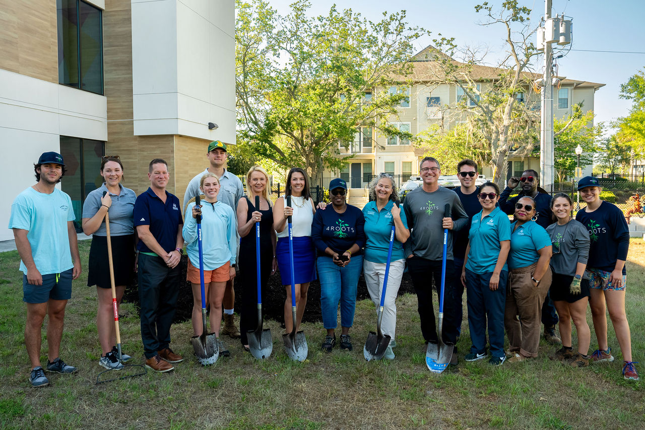The B&G club garden event with members standing with shovels.
