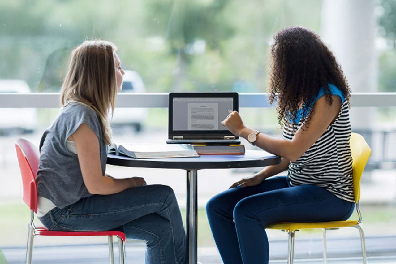 Two people looking at a computer